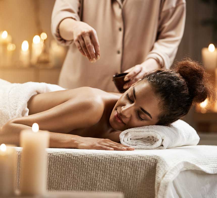 tender-african-woman-relaxing-enjoying-healthy-spa-massage-with-oil